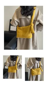 Detail of ginger quilted crossbody bag showing soft fabric texture and decorative side knots