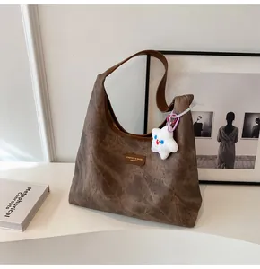 Detail of vintage brown tote bag texture with star charm in cozy lifestyle setting