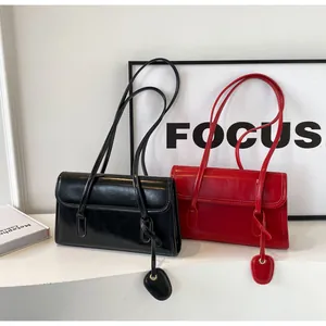 Detail of vintage square flap shoulder bags in black and red glossy finish