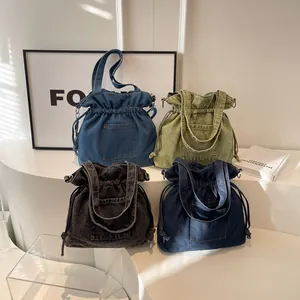 Trendy denim drawstring bucket bags in four colors with portable handles and pockets