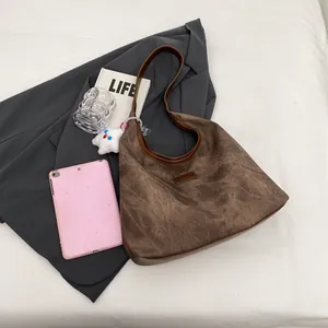 Vintage brown leather hobo bag with large capacity displayed on a neutral background