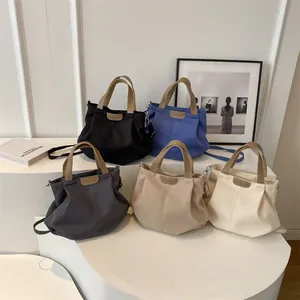 Minimalist canvas tote bag set in five colors with faux leather straps for daily commute