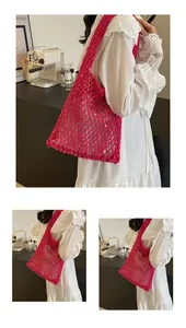 Detail of rose red handmade woven tote bag with large hollow mesh cotton rope texture