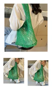 Detail of green woven mesh tote bag with silver inner pouch for summer beach vacation