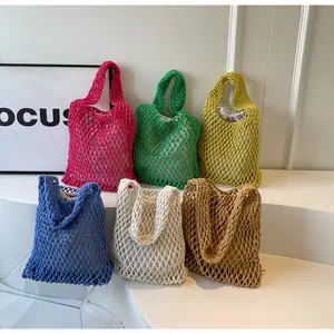 Detail of colorful woven tote bags with mesh structure and drawstring canvas liner