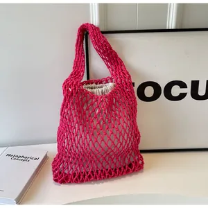 Detailed close-up of pink woven mesh tote bag with a beige fabric drawstring liner