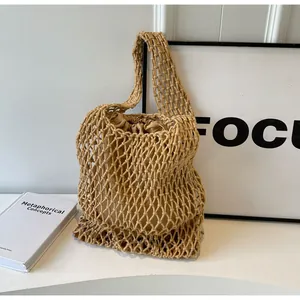 Detailed close-up of woven mesh tote bag with a beige drawstring inner liner for beach