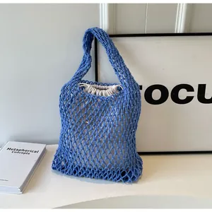 Blue woven cotton mesh tote bag detail featuring white drawstring canvas inner pouch