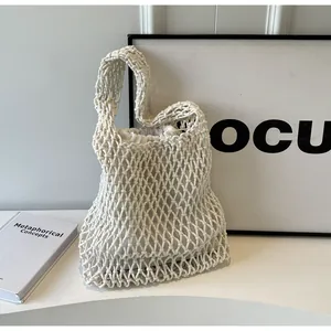Detailed view of white woven rope tote bag with mesh texture and inner drawstring pouch