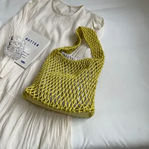 Handmade woven tote bag in lime yellow with mesh design and drawstring inner pouch