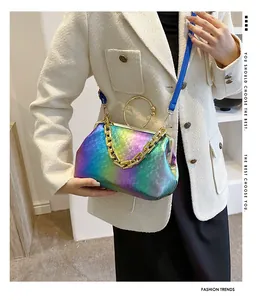 Detail view of rainbow gradient crossbody bag featuring gold chain and metal handle
