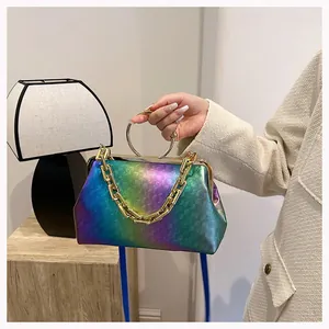 Detail view of the iridescent gradient handbag featuring gold chain and metal ring handles