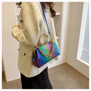 Detail of rainbow gradient embossed crossbody bag with gold ring handle and chain