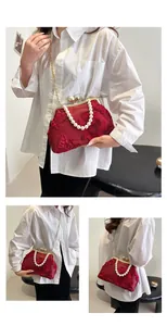 Detail of red floral embroidery on vintage silk bag with pearl strap and gold chain
