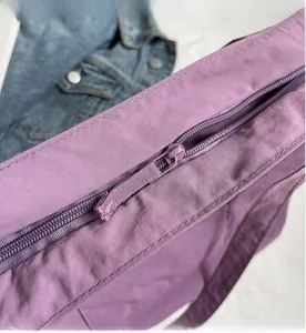 Close-up of smooth purple nylon tote bag zipper closure with premium stitching detail