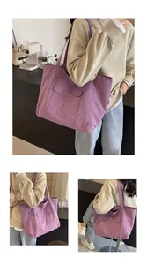 Macro view of purple nylon tote bag showing durable fabric texture and front pocket detail