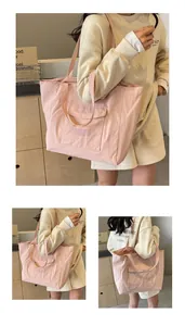 Close-up of pink nylon tote bag showing the front flap pocket and durable material texture
