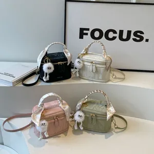 Chic textured mini bucket bags in four colors with printed handles and plush charms
