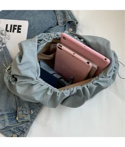 Top view of spacious interior of light blue pleated bag showing ample storage for tablets