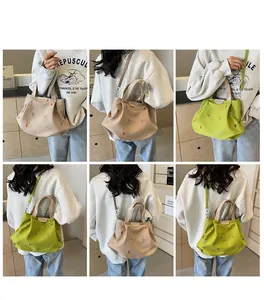 Multiple views of a canvas tote bag with colorful letter embroidery shown on a model