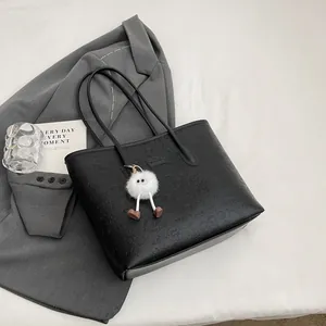 Large capacity black tote bag with cartoon embossing and a cute plush monster charm