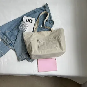 Minimalist beige nylon tote bag with front pocket for daily commute and students