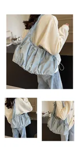 Detail view of light blue pleated cloud tote bag with adjustable side drawstrings