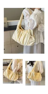 Detail of light yellow pleated cloud shoulder bag showing soft fabric and drawstrings