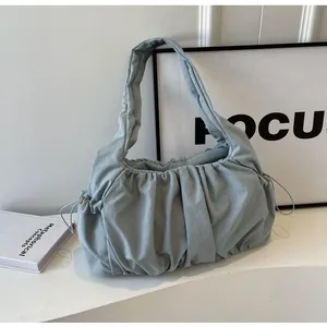 Detailed view of the light blue pleated cloud bag featuring a drawstring closure and soft texture