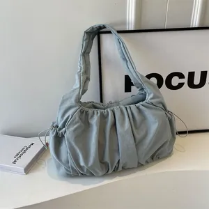 Minimalist light blue pleated cloud bag with soft fabric and stylish drawstring detail