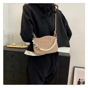 Détail du sac bandoulière matelassé kaki avec chaîne de perles cœur et rabat à bord ondulé