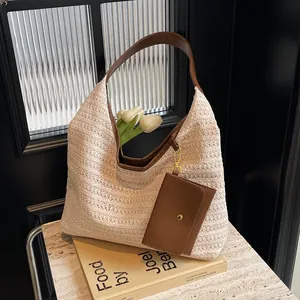 Chic beige straw woven tote bag with brown leather straps and detachable pouch