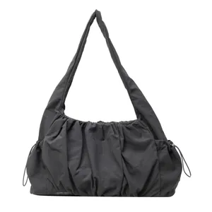 Minimalist charcoal grey ruched shoulder bag with drawstring details and cloud design