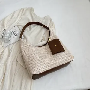 Large capacity straw tote bag with brown leather details and small hanging card pouch