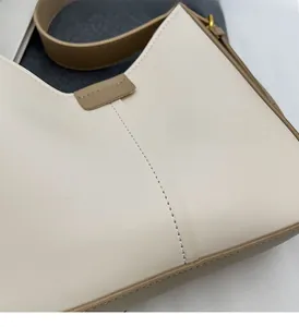 Détail de la texture en similicuir souple et coutures précises sur le sac bandoulière
