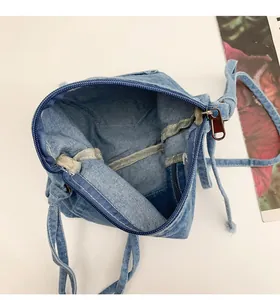 Detail view showing the spacious interior and zipper closure of the denim bucket bag