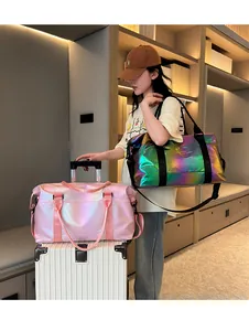 Detail of laser iridescent travel bag on silver suitcase with adjustable strap