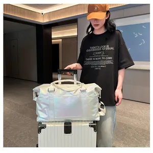 Iridescent white fitness bag with laser texture on white suitcase in a modern hallway