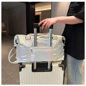 Rear view of holographic travel bag showing trolley sleeve attached to a white suitcase