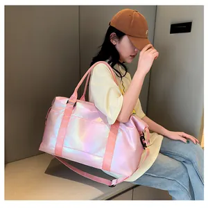 Pink holographic waterproof travel bag with reinforced handles and adjustable strap
