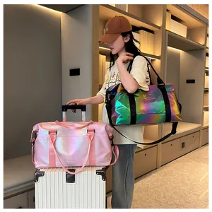 Detail of laser travel bag with glossy finish on a white suitcase in a chic setting