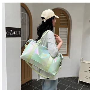 Iridescent green travel bag with crossbody strap shown in an outdoor cafe setting