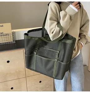 Detalle del bolso tote de malla verde militar con gran capacidad y textura transpirable