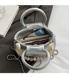 Top view of silver pleated cloud bag showing spacious interior with wallet and phone