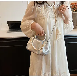 Silver pleated cloud bag with metallic ring handle and decorative marble beads detail