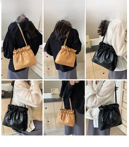 Detailed views of the pleated bucket bag in black and khaki colors on a model
