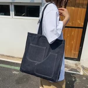 Deep blue denim tote bag with white contrast stitching and double front pockets