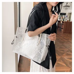 Detail view of large transparent PVC tote bag with graffiti art and inner pouch