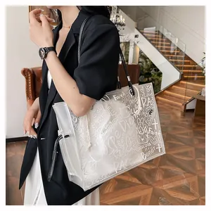 Detail of transparent PVC tote bag featuring white graffiti prints and inner drawstring pouch