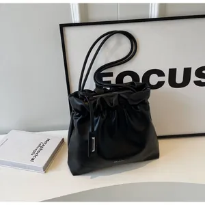 Close-up of black hobo bag with pleated texture and stylish double shoulder straps